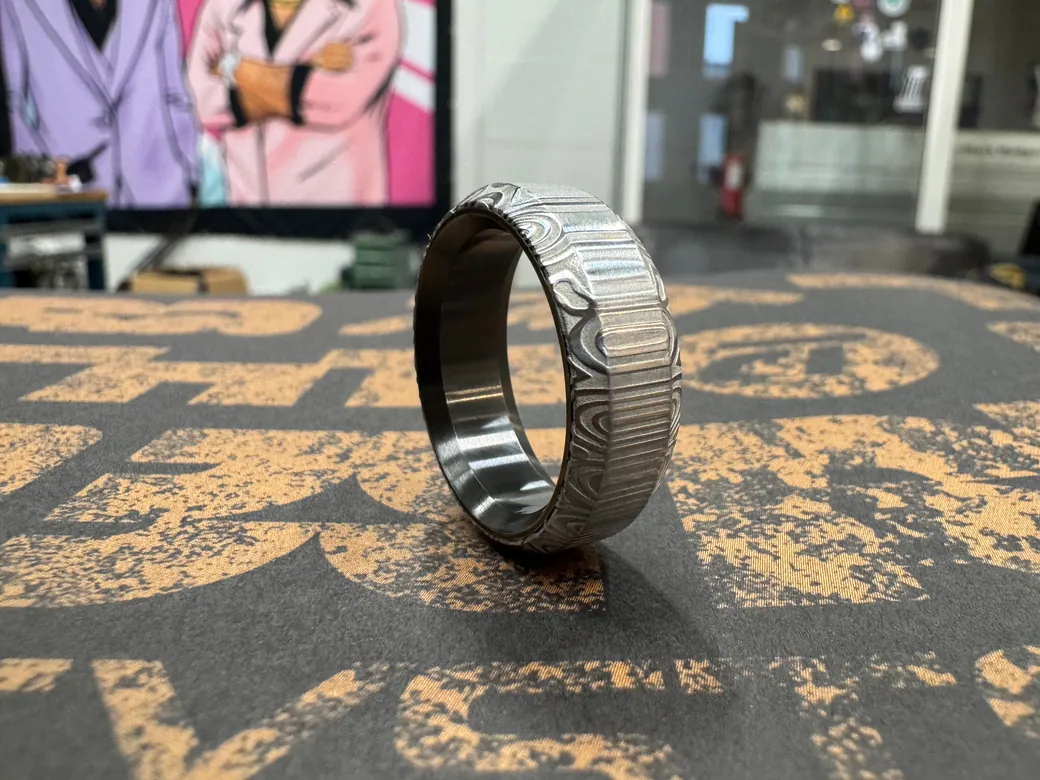 Bluetongue Damascus Steel and Zirconium ring
